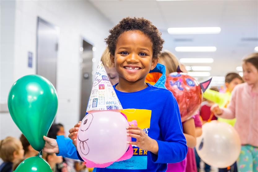 Students participate in a balloon parade